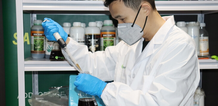 Ihumate technician monitoring physical and chemical indicators with precision instruments.